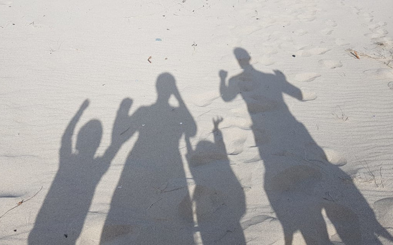 Shadow of family on beach