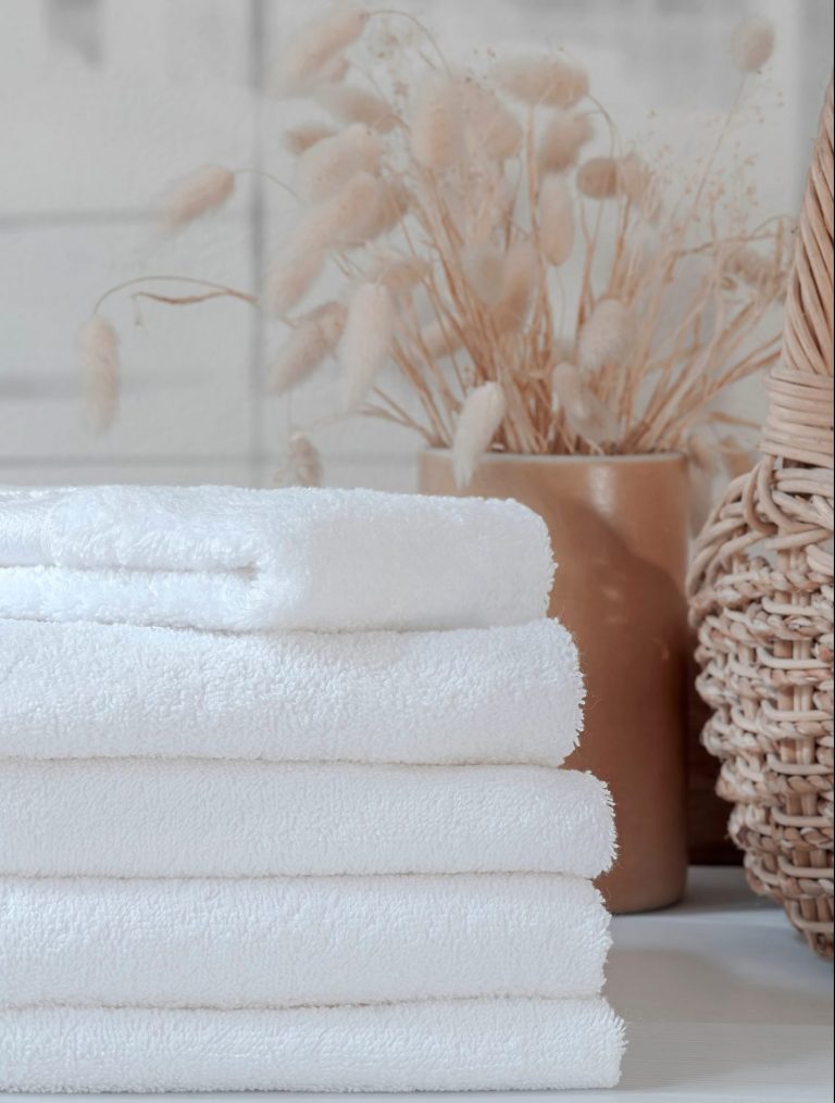 Stack of white towels from furnished holiday let