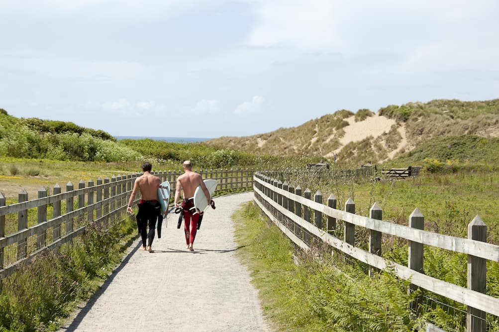 Surfers walking to Croyde beach