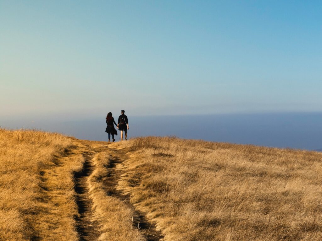 A couple walking, holding hands on Exmoor